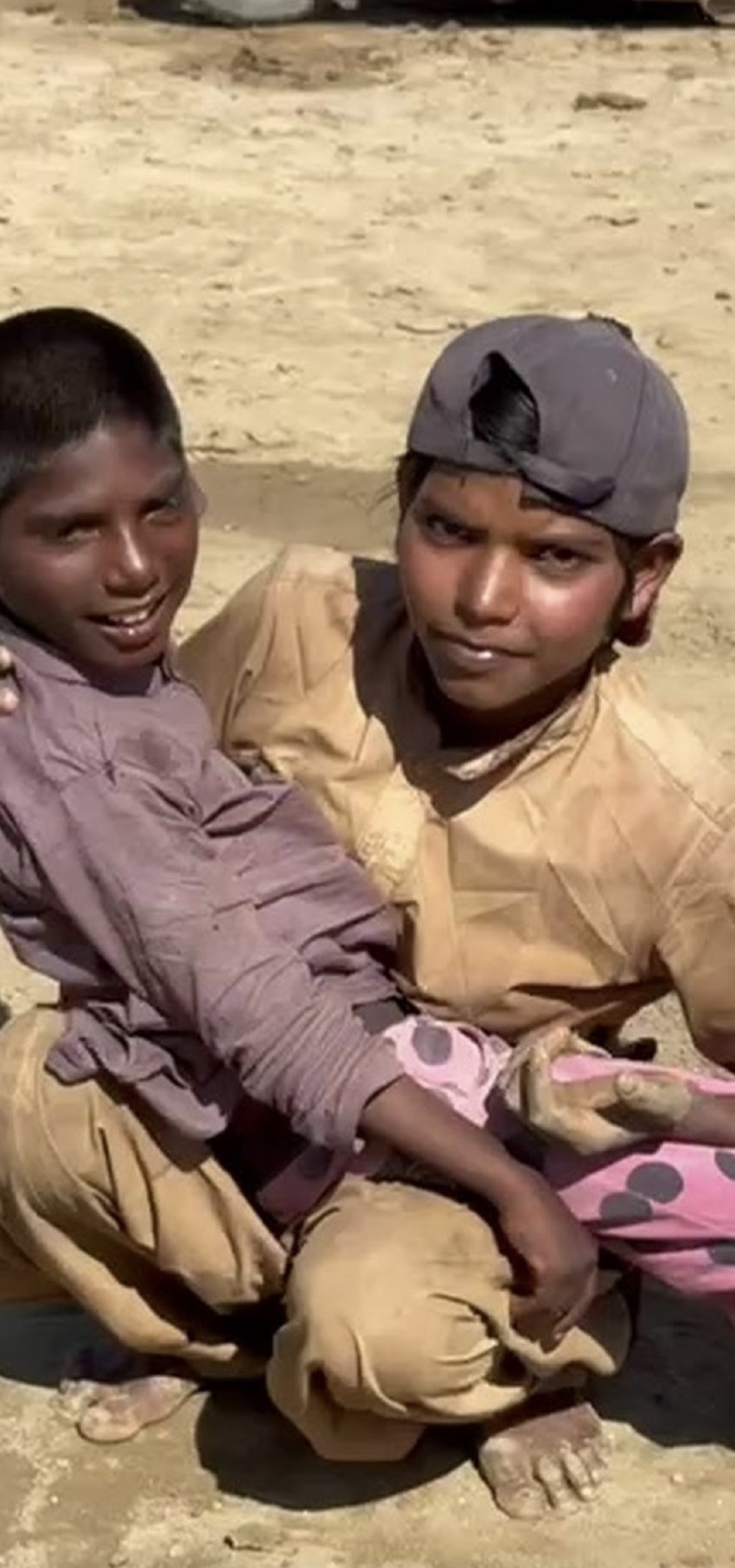 Anita, holding her little brother — the day our team met them